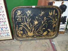 A large Japanned style papier mache serving Tray having rounded corners, in gilt and black ground,
