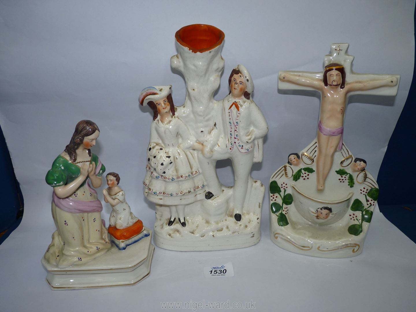 A flatback Staffordshire holy water stoup depicting Christ on the cross,