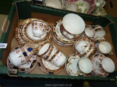 A quantity of Imari style china in various patterns including cups, saucers, plates and bowl.