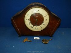 A Smiths mantle clock with key and pendulum.