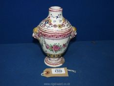 An old porcelain pot pourri in the shape of an urn with mask handles in the form of Shakespeare