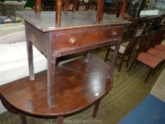 A circa 1800 peg-joyned Oak Side Table having a frieze drawer with turned knobs and standing on
