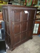 A dark Jacobean Oak panelled Hall Cupboard, peg-joined and with period forge-made 'H' hinges,