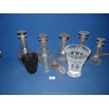 Five glass decanters with stoppers, 2 spare stoppers, together plus a heavy cut glass vase,