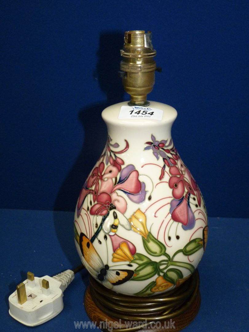 A Moorcroft pottery table lamp, 'Family through flowers' design, 11 1/2" tall.