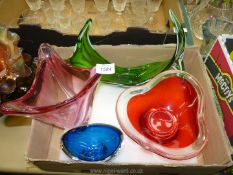 Four decorative vases and a bowl in red, green, blue and pink.