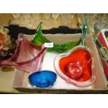 Four decorative vases and a bowl in red, green, blue and pink.