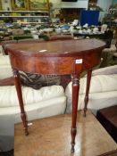 A Mahogany demi-lune side Table standing on turned legs,