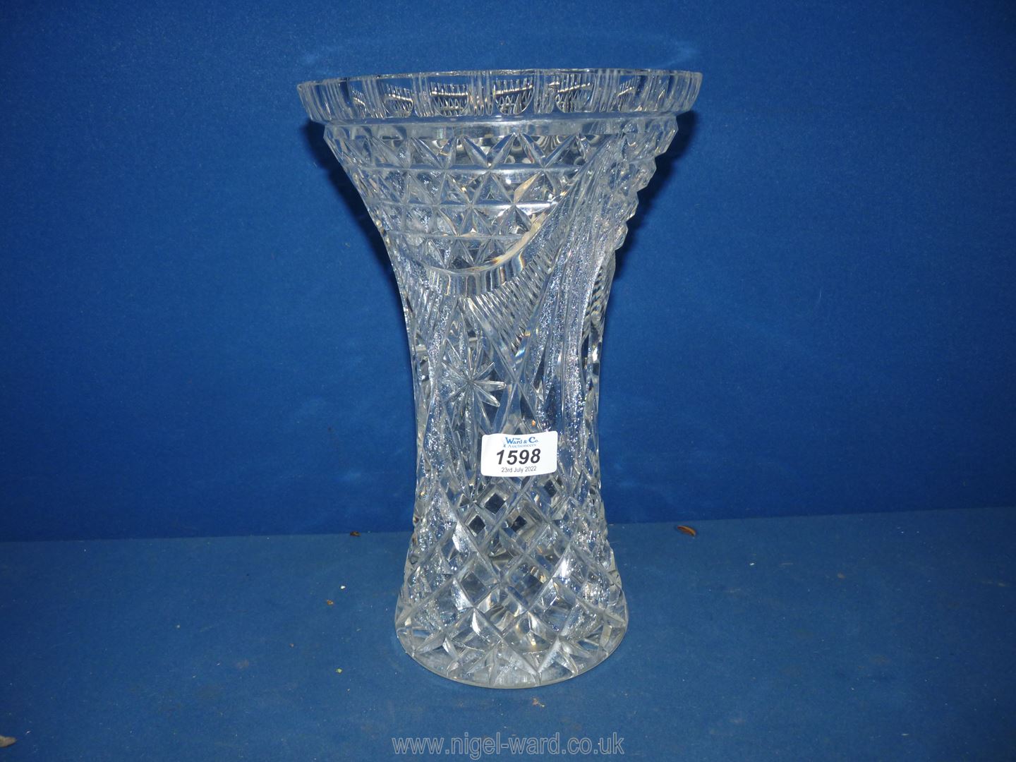 A tall cut glass vase (small chip to rim) 11 1/2" tall.