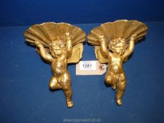 A pair of small gilded wooden cherubic candle sconces, 4" high.