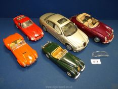 Five model cars including Burago Porsche 356B, Jaguar XK 120, Cobra 427,