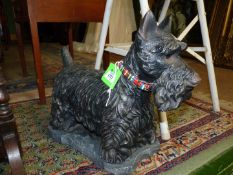 A cast iron Scotty Dog on stone plinth, 10" high, signed and dated 1996 to base.