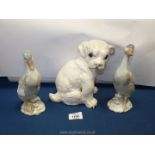 A white glazed dog/pug and two china ducks.