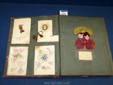 An old album (a/f.) containing a collection of greetings cards from the early 20th c.