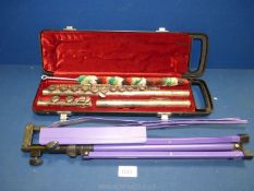 A cased Yamaha YFL211S flute with a purple adjustable music stand.