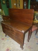 A Georgian Mahogany swing-leg dropleaf Dining Table having pade feet,