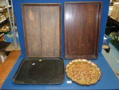 Four trays: two rectangular wooden, a black papier mache tray and one other.
