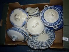 A quantity of blue and white china including tureens, gravy jug, meat plate and plates,