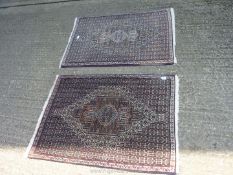 A pair of Iranian hearth Rugs in brown, blues and greens, 41 1/2'' long x 29'' wide.