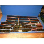 A quantity of Edwardian glass slides.