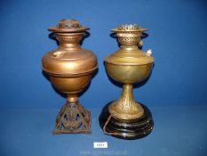 A brass oil lamp and another in copper (one converted to electric.