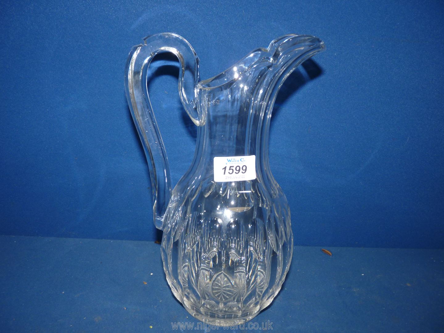 A good quality cut glass water Jug in ewer style with thumb cut detail, 11'' tall.