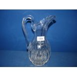 A good quality cut glass water Jug in ewer style with thumb cut detail, 11'' tall.