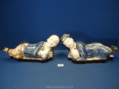 Two Chinese ceramic headrests, man and woman, 16'' long x 8'' high, hairline cracks.