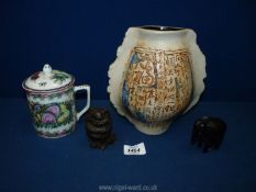 A box containing a Malaysian pottery vase, Famille Rose coffee cup with lid, a cat and an elephant.