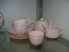 A Minton's part Tea for Two set in pink with gilt edging.