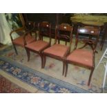 A matched set of four Dining Chairs comprising three having sabre legs and pierced cross-splats,