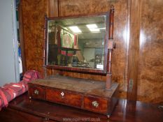 A Georgian Mahogany swing Mirror having a base with three drawers having brass knobs,