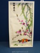 A framed oriental Embroidery depicting ducks on pond under a blossom tree,