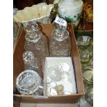 Two square glass decanters with stoppers, miscellaneous spare stoppers, and four small glass salts.