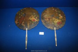 A pair of pretty papier mache fans with floral design and pierced bone work handles.