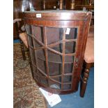 A most unusual bow fronted Mahogany framed geometrically glazed wall hanging Corner Cabinet with