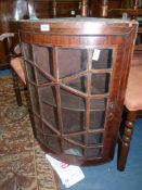 A most unusual bow fronted Mahogany framed geometrically glazed wall hanging Corner Cabinet with