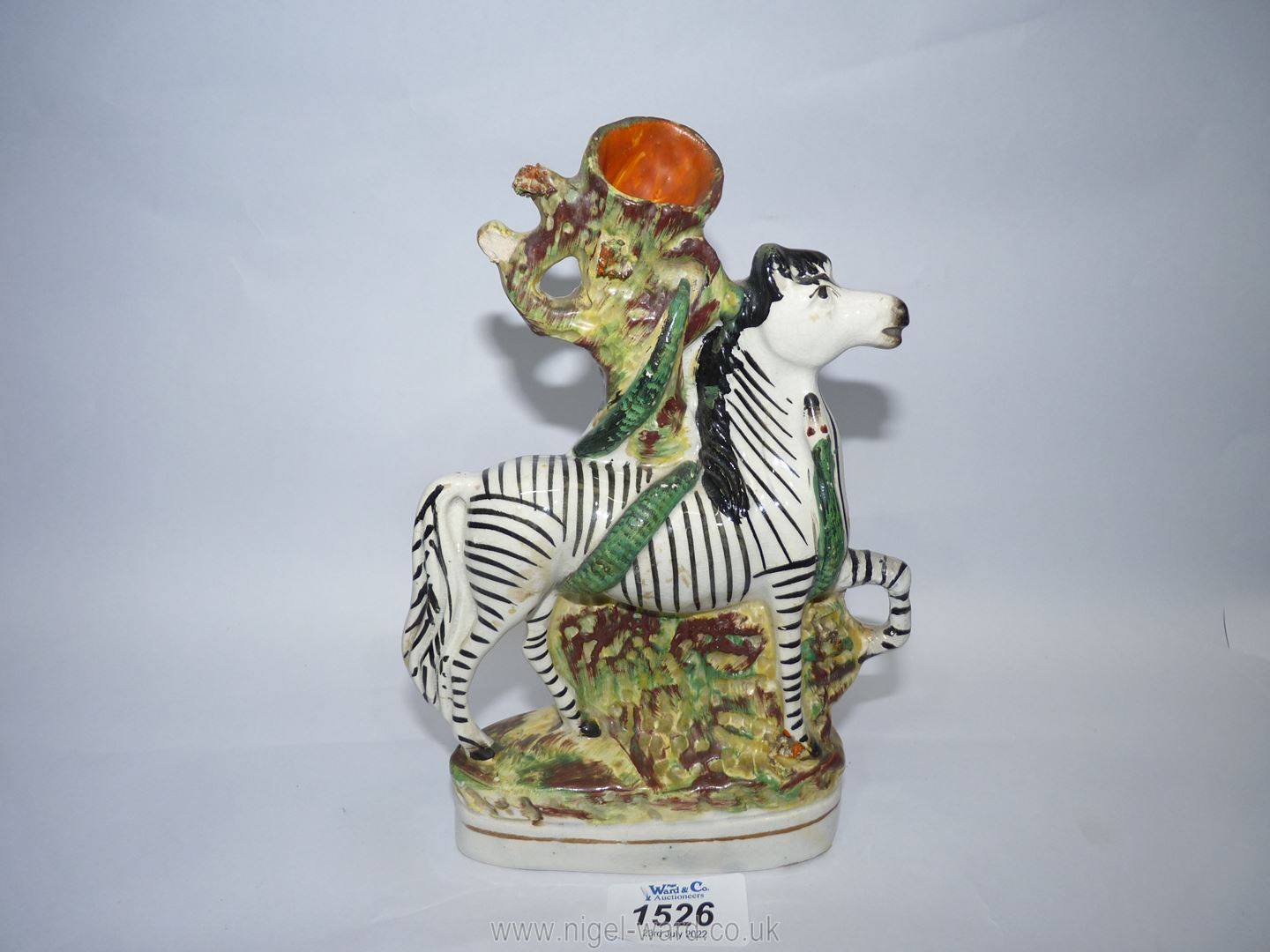 A Staffordshire Zebra with snake spill vase, 6'' wide x 8 1/4'' high, some crack and repairs.