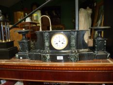 A black and green slate Clock and garniture set.