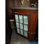 A circa 1900 Mahogany wall hanging corner Cabinet having a nine-pane glazed door,