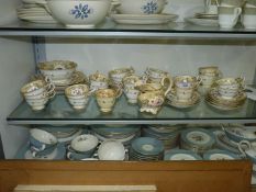 A quantity of elegant cream and gilt tea ware with painted floral decoration, marked S86 to base,