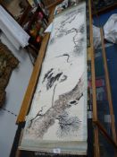 An oriental hand painted scroll of a heron on a branch in brown and black with just the top of the