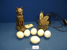 A Tiffany style small side light, butterfly shape, modern metal Egyptian cat and six alabaster eggs.