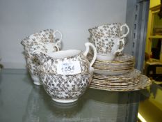A Crown Regent part Teaset in gold with all over floral pattern.