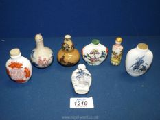 Seven porcelain Oriental snuff bottles, some with character marks to base.