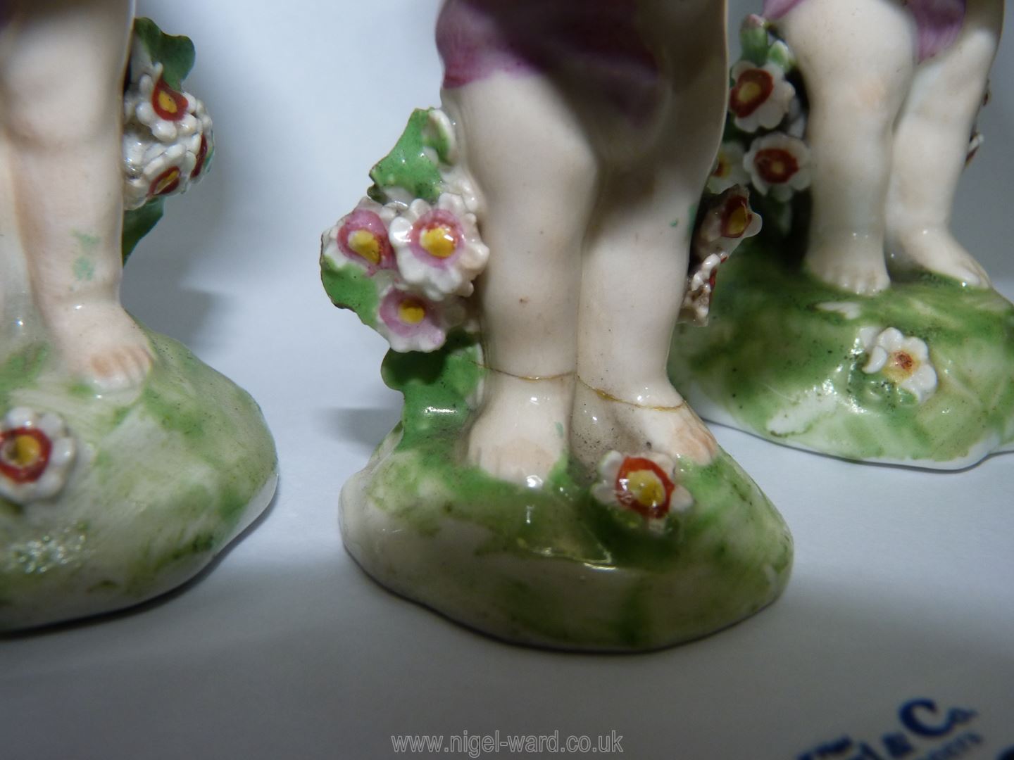 Three Derby porcelain Putti holding flower baskets, some damage, 4'' and 3 1/2'' tall. - Image 3 of 4