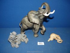 Two elephant ornaments and a small puppy ornament.