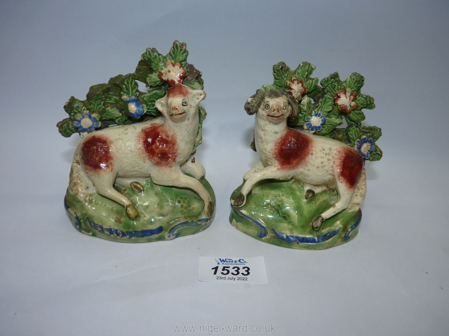 A pair of Staffordshire Sheep spill holders, 4 3/4'' high,