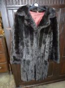 A luxury Barmink faux fur Coat by Dunbar in dark brown, size 14, 52% modaacrylic and 48% acrylic.