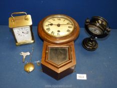 A black Bakelite clock, a wall clock and a carriage clock.